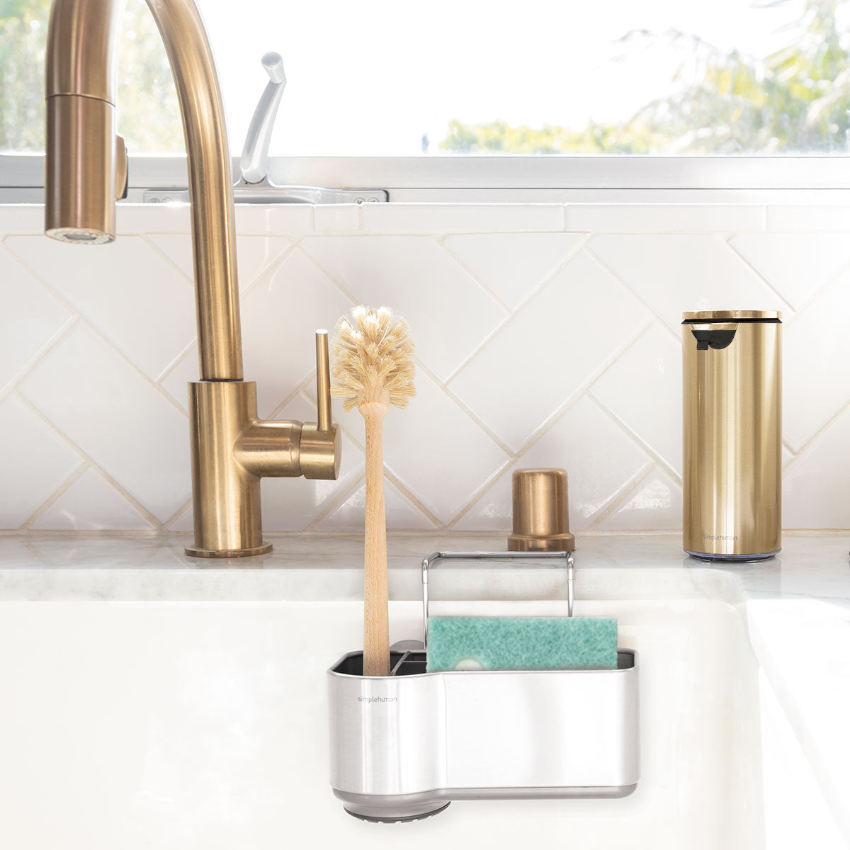 Simplehuman Brushed Stainless Steel Sink Caddy organizing sponge and brush inside sink basin, space-saving design.