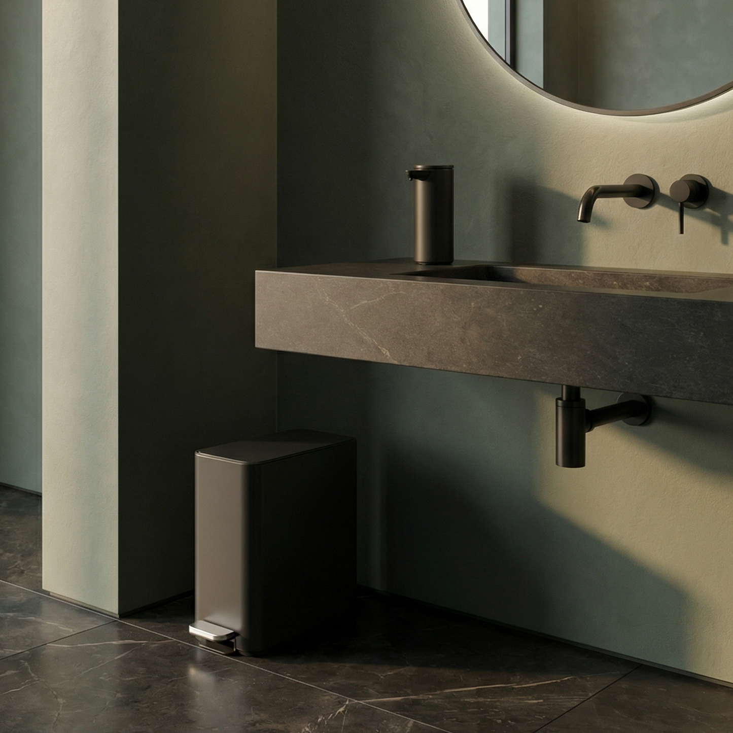 Simplehuman's 9L Slim Step Can in Matte Black in a simple bathroom featuring the Matte Black Simplehuman Sensor Pump on a black marble sink countertop.
