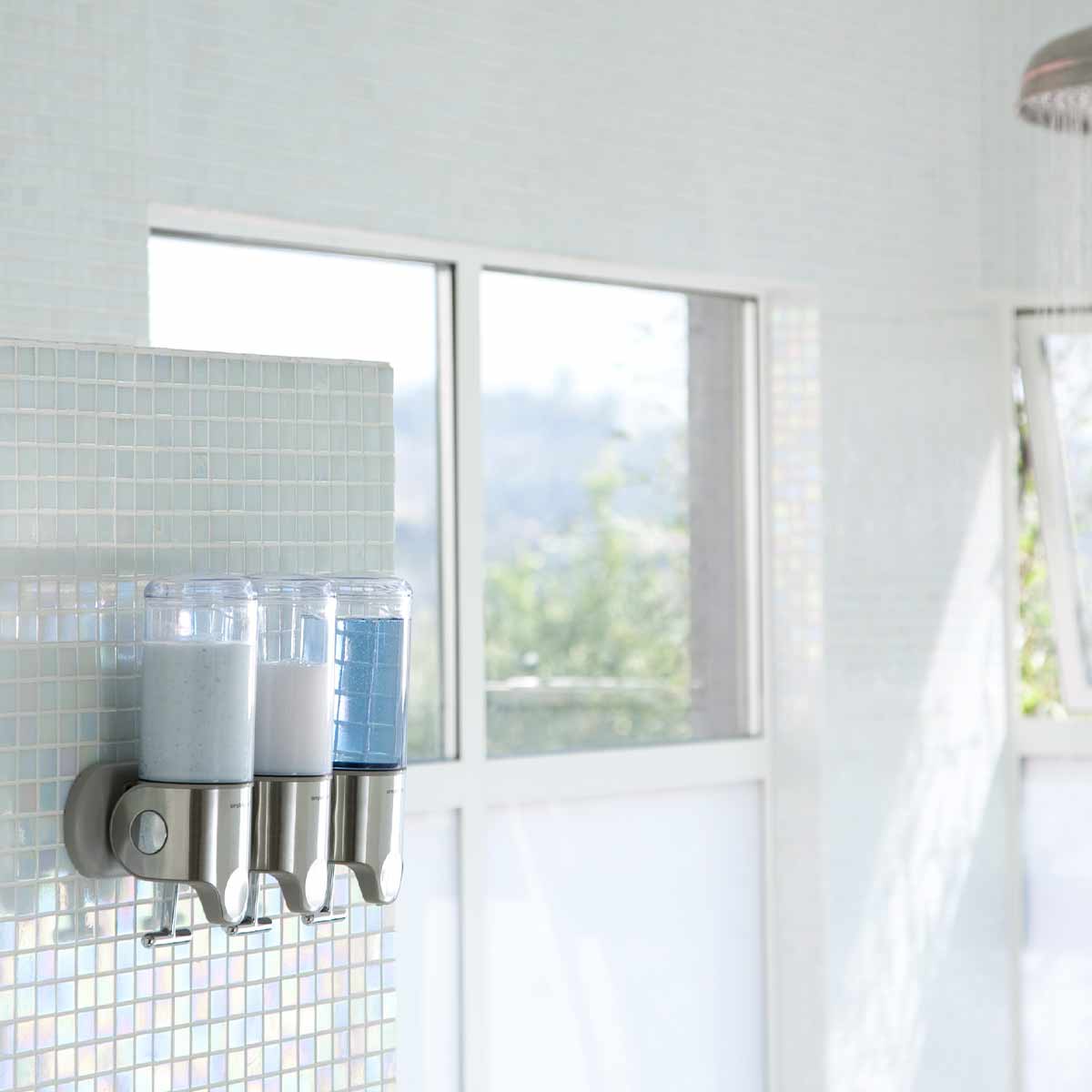 Simplehuman Brushed Stainless Steel Triple Wall Mount Pump in shower, space-saving dispenser for shampoo and soap.