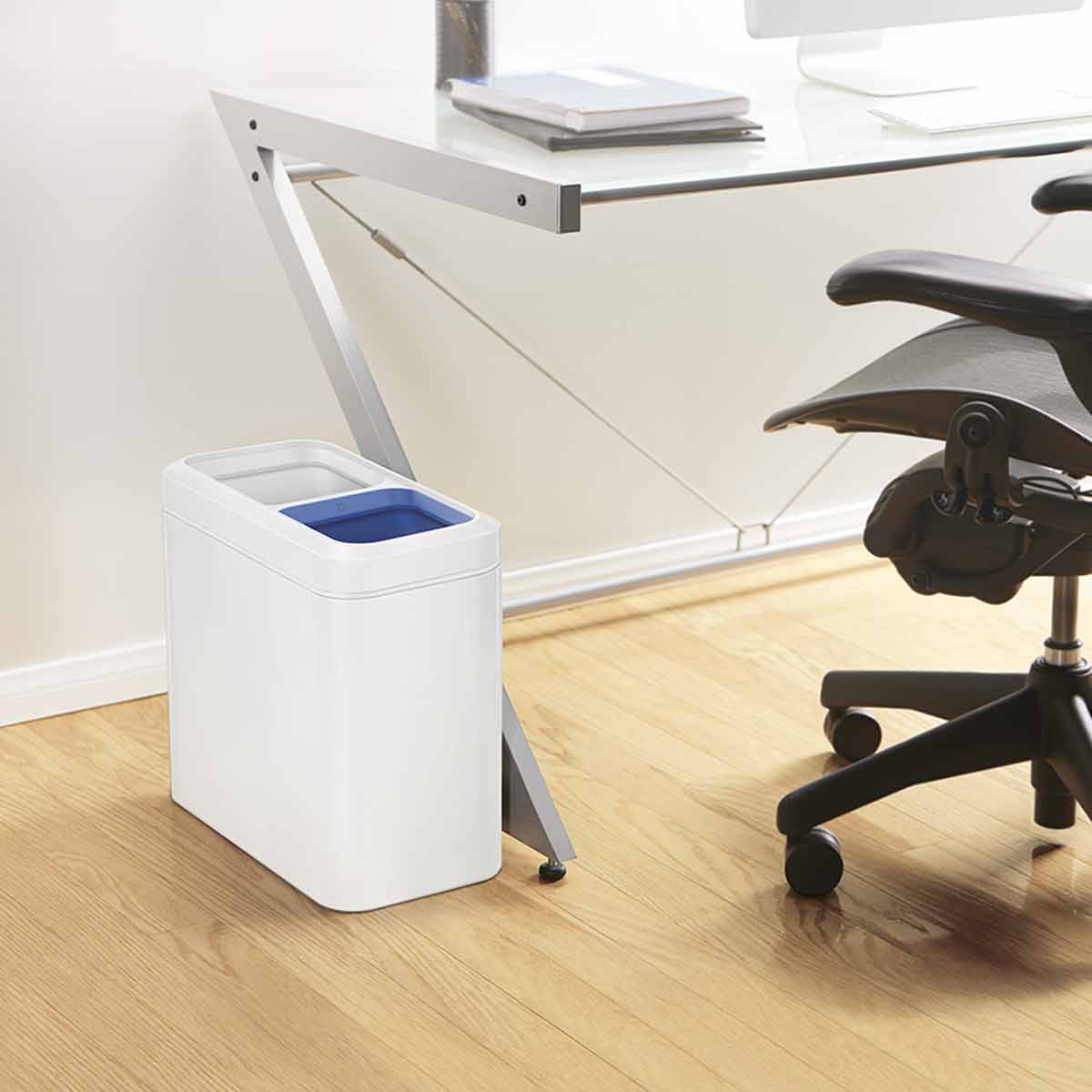 Simplehuman White 20L Dual Slim Open Can under an office desk, perfect for space-saving trash and recycling.