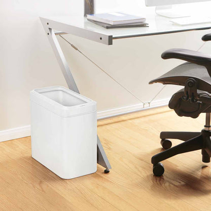 Lifestyle view of Simplehuman 25L Slim Open Can in White, fits neatly under a modern desk, quick access.
