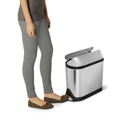 Usage view of Simplehuman Brushed Stainless Steel 10L Butterfly Step Can, person activating the hands-free pedal to open the split lid.