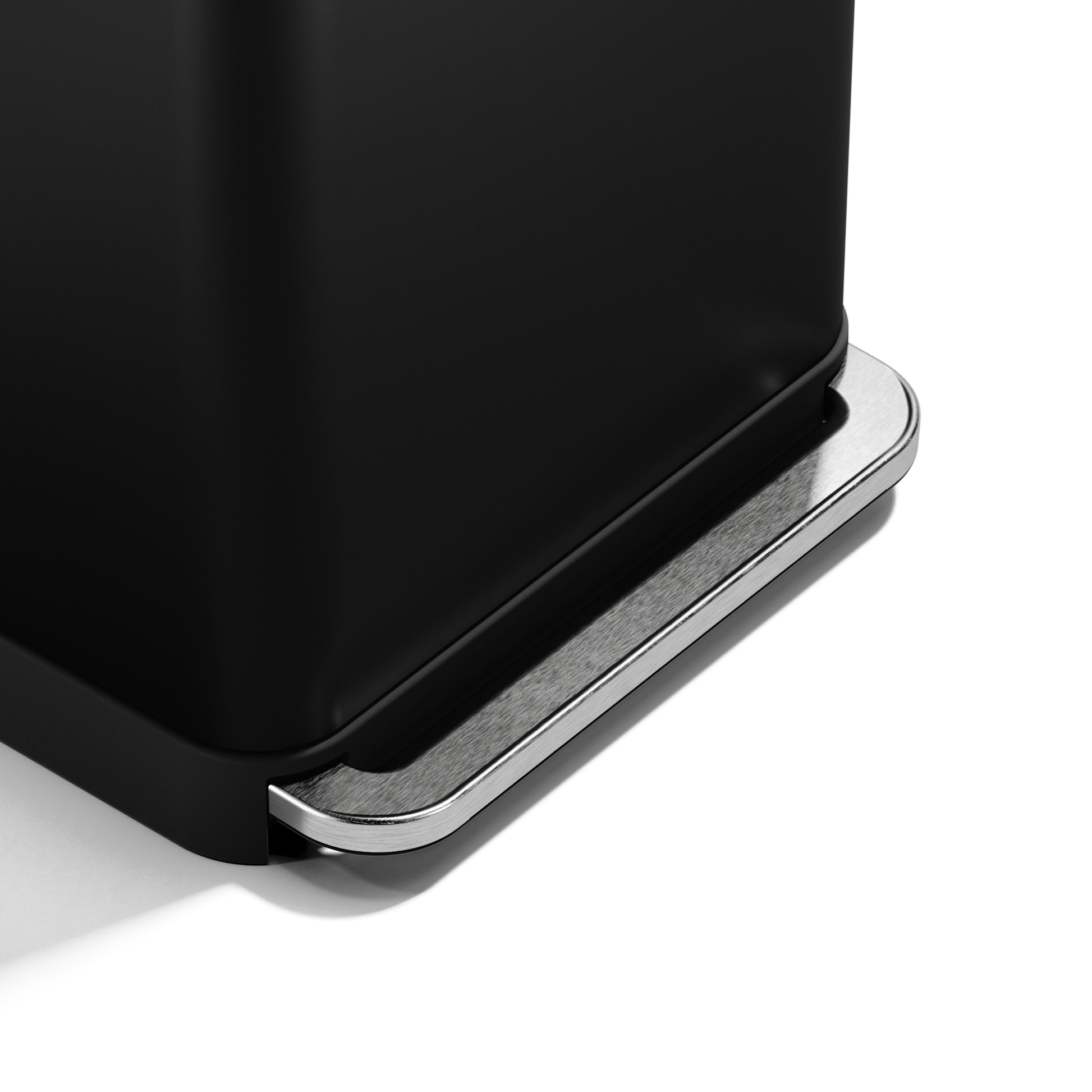 Close-up of Simplehuman 55L Rectangular Step Can pedal in Matte Black, showing hands-free stainless steel mechanism.