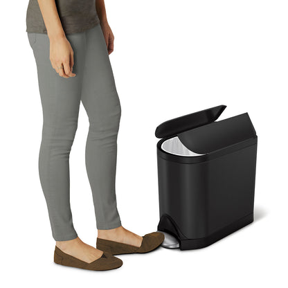 Action view of Simplehuman Matte Black 10L Butterfly Step Can, hands-free pedal opening the split lid.