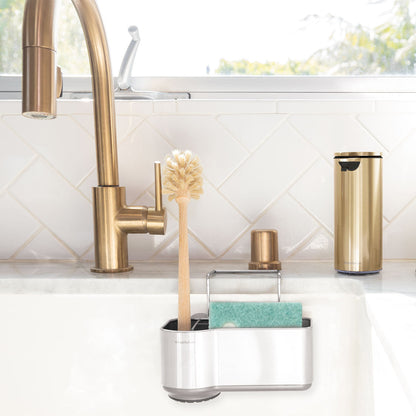 Simplehuman Brushed Stainless Steel Sink Caddy organizing sponge and brush inside sink basin, space-saving design.