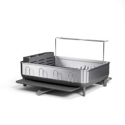 Angled view of Simplehuman Brushed Stainless Steel Dishrack, featuring a removable utensil caddy and pivoting drain spout.
