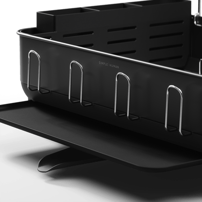 Detail view of Simplehuman Matte Black Steel Frame Dishrack showing integrated cup hooks and pivoting drain spout.