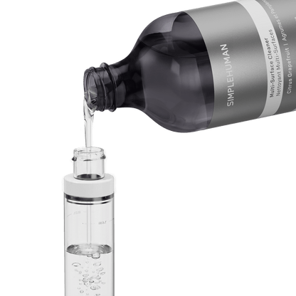 Simplehuman's Refill Bottle filling a Simplehuman Paper Towel Holder with Spray.